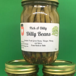 A jar of dilly beans on top of three other jars.