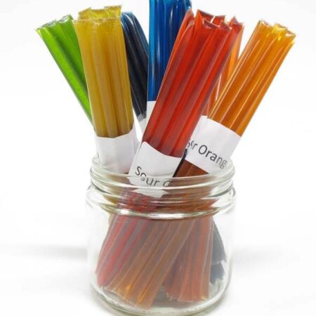 A jar of colored lollipops in a glass